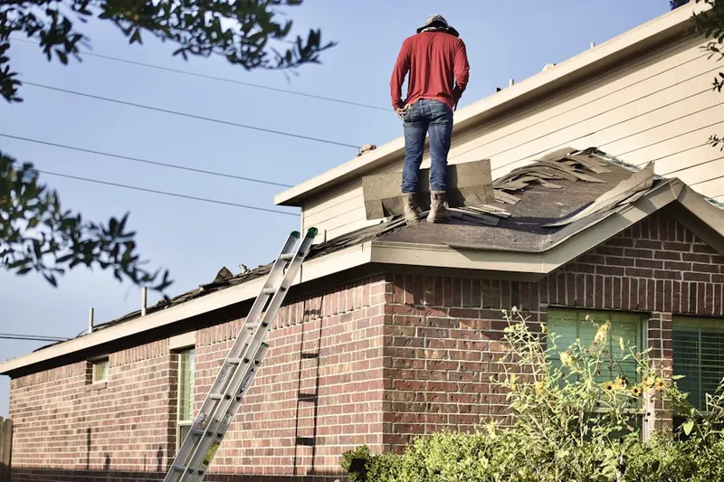 Professional roofer working on a residential roof in Vineyard Point Village